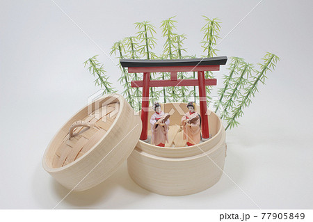 A Geisha on a flowering tree branches background A Geisha on a flowering tree branches background 77905849