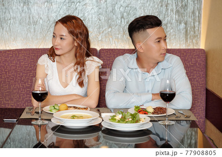 Couple not talking at dinner Couple not talking at dinner 77908805