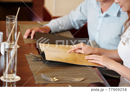 Woman pointing at menu Woman pointing at menu 77909258