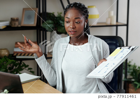 Businesswoman talking at online meeting Businesswoman talking at online meeting 77911461