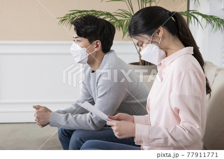 Asian couple waiting for covid test result 77911771