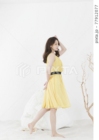 beautiful Asian model in yellow dress, spring beauty concept beautiful Asian model in yellow dress, spring beauty concept 77912077