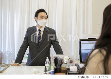 Asian businessman, customer with mask ordering menu, business during covid virus concept Asian businessman, customer with mask ordering menu, business during covid virus concept 77912629
