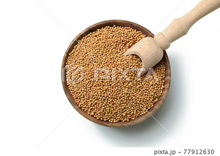 Bowl with mustard seeds and scoop isolated on white background Bowl with mustard seeds and scoop isolated on white background 77912630
