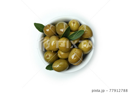 Bowl of green olives isolated on white background Bowl of green olives isolated on white background 77912788