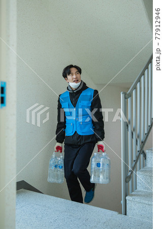 Asian delivery man, delivering boxes, goods to customers 77912946