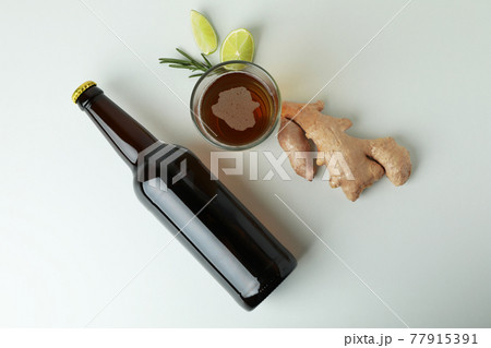 Glass and bottle of ginger beer, and ingredients on white background Glass and bottle of ginger beer, and ingredients on white background 77915391