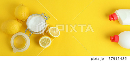 Jar of acid powder, lemons and detergents on yellow background 77915486