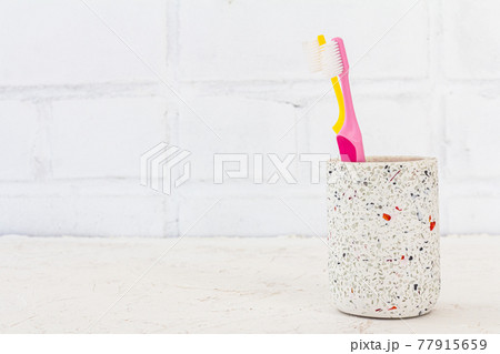 Can with toothbrushes on a white background. Can with toothbrushes on a white background. 77915659
