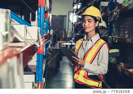 Female warehouse worker working at the storehouse Female warehouse worker working at the storehouse 77916208
