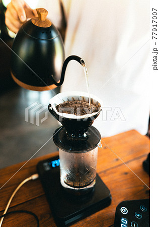 Drip coffee, barista pouring water on coffee ground with filter Drip coffee, barista pouring water on coffee ground with filter 77917007