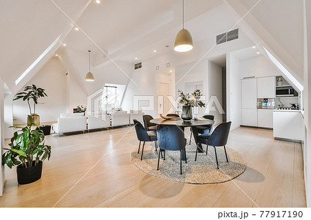 Attic apartment interior with round table 77917190