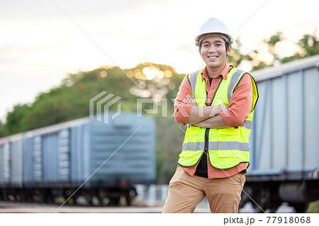 Portrait Engineer man working on railway. Chief Engineer in the Hard Hat in maintenance facility, Engineer and repair man concept. Safty first Portrait Engineer man working on railway. Chief Engineer in the Hard Hat in maintenance facility, Engineer and repair man concept. Safty first 77918068