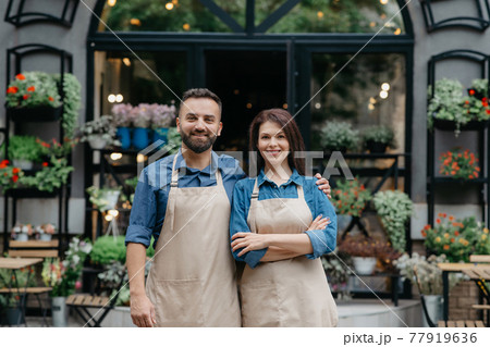 Owners of flower shop near showcase outdoor Owners of flower shop near showcase outdoor 77919636