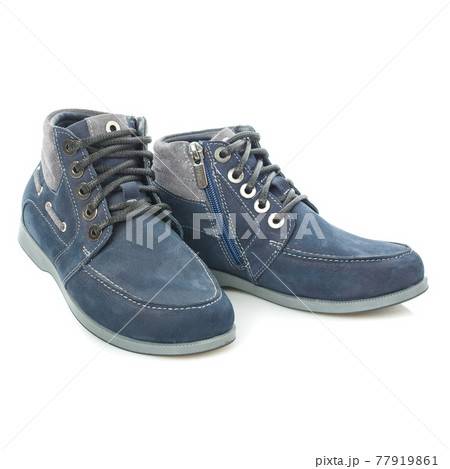 Men's blue leather boots isolated on a blue background. Men's blue leather boots isolated on a blue background. 77919861