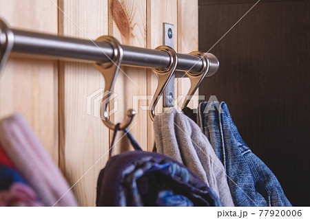 Kid's cloth hanginig on metal hooks. Close-up. Kid's cloth hanginig on metal hooks. Close-up. 77920006