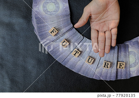 Close-up and selective focus right hands of fortune teller who supine hand for to invite people to choose tarot cards and listen to predictions about future destiny, Divine magic concept, top-view 77920135