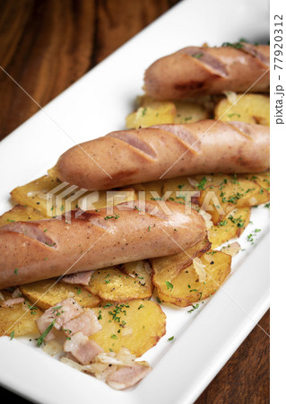 german cheese sausages with fried potato and mustard 77920312