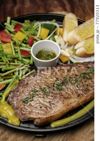 organic tenderloin beef steak sizzler on hot plate meal platter 77920313