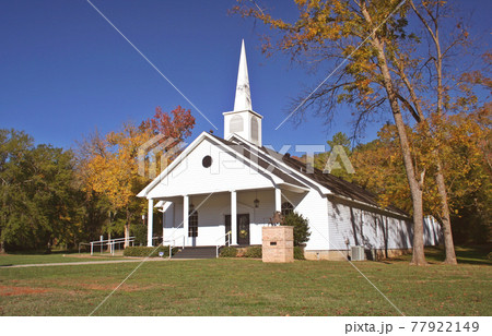 Rural Church in Autumn. White Church with leaves Rural Church in Autumn. White Church with leaves 77922149