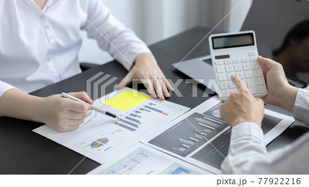 Brainstorm team, Marketers and financial accountants are discussing and analyzing charts to plan strategies to meet customer needs, Using graphs and laptops to analyze business data, Meeting concept. Brainstorm team, Marketers and financial accountants are discussing and analyzing charts to plan strategies to meet customer needs, Using graphs and laptops to analyze business data, Meeting concept. 77922216