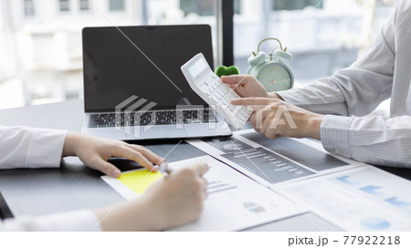 Brainstorm team, Marketers and financial accountants are discussing and analyzing charts to plan strategies to meet customer needs, Using graphs and laptops to analyze business data, Meeting concept. 77922218