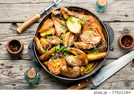Chicken baked with potatoes in a pan,top view Chicken baked with potatoes in a pan,top view 77922284
