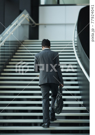 African American Businessman Walking Up Stairs 77924041