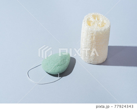 Loofah and konjac natural zero waste plant sponges for washing and scrubbing body and face on blue Loofah and konjac natural zero waste plant sponges for washing and scrubbing body and face on blue 77924343