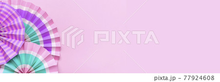 Traditional Japaneses festival paper fan with pink, turquoise, white stripes Birthday party, celebration holidays concept Abstract background Wall decor Banner 77924608