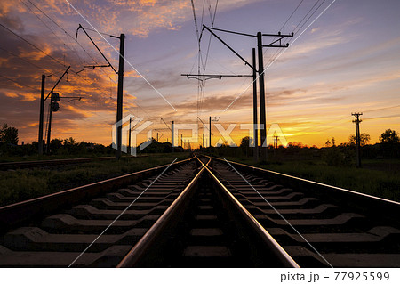 Railroad at sunset. Rail Freight and Passenger Transportation. Railroad at sunset. Rail Freight and Passenger Transportation. 77925599