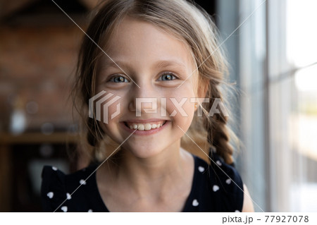 Portrait of happy cute kid, looking at camera and smiling 77927078
