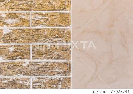 Dark yellow brick wall with abstract pattern and beige tile texture modern building facade background 77928241