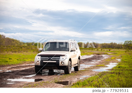 Mitsubishi Pajero (Montero) at dirt road after rain Mitsubishi Pajero (Montero) at dirt road after rain 77929531