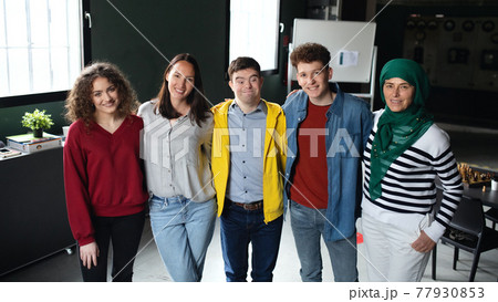 Down syndrome man with friends in community center, inclusivity and unity concept. 77930853