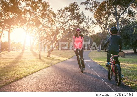 Mother with her son riding riding in the park 77931461