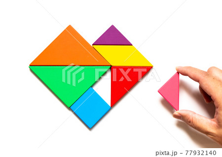 Color wood tangram puzzle in heart shape wait to fulfill on white background Color wood tangram puzzle in heart shape wait to fulfill on white background 77932140