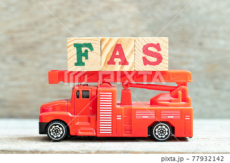 Fire ladder truck hold letter block in word FAS (Abbreviation of Fetal alcohol syndrome, Free alongside or Financial accounting standards) on wood background Fire ladder truck hold letter block in word FAS (Abbreviation of Fetal alcohol syndrome, Free alongside or Financial accounting standards) on wood background 77932142