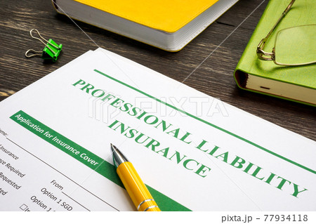 Professional liability insurance and yellow pen for signing. 77934118