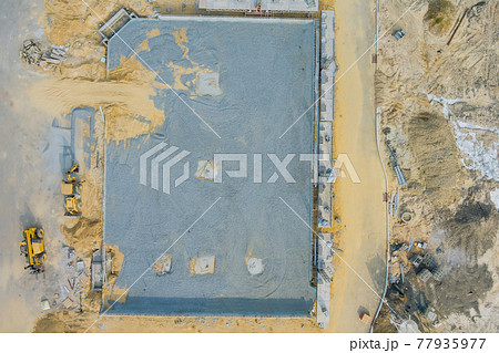 Aerial view on the construction site of mounting concrete brick walls 77935977