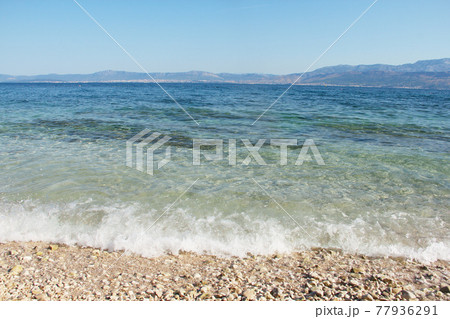 Pebbles beach with waves 77936291