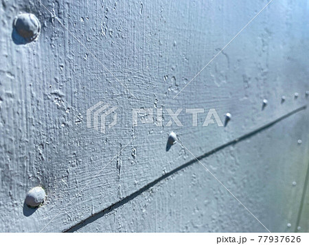 Rusty painted metal in blue. The texture of rust and blue stealing on a metal surface. Rusty Metal Background 77937626