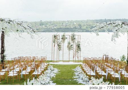 Premium arch for wedding ceremony for newlyweds on the river bank with wisteria trees 77938005