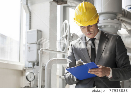 Industrial working men at factory working away Industrial working men at factory working away 77938888