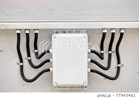 External electrical junction box with corrugated cable channels and wires. Professional wire 77943481