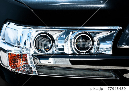 Crystal optics of the SUV. Front lights of a passenger car close-up. Crystal optics of the SUV. Front lights of a passenger car close-up. 77943489