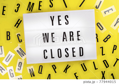 Lightbox with text YES. WE ARE CLOSED on yellow background with letters around 77944015