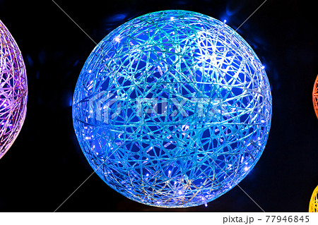 Abstract neon futuristic magic glowing art LED background with wicker shapes multicolored blue, red pink purple yellow orange balls with plastic fiber texture in black space Abstract neon futuristic magic glowing art LED background with wicker shapes multicolored blue, red pink purple yellow orange balls with plastic fiber texture in black space 77946845