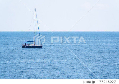Sailing yacht in the blue calm sea. Sailing yacht in the blue calm sea. 77948027