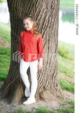 Girl little cute child enjoy peace and tranquility at tree 77949482